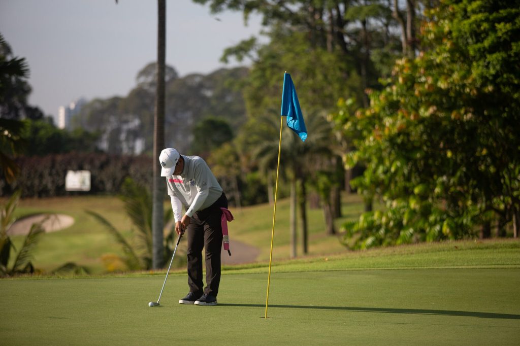 Putting on a green with the Johor Bahru skyline behind